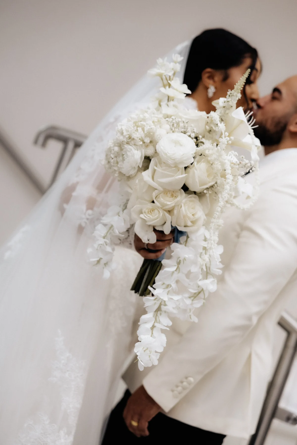 Newlyweds together with a white bridal bouquet