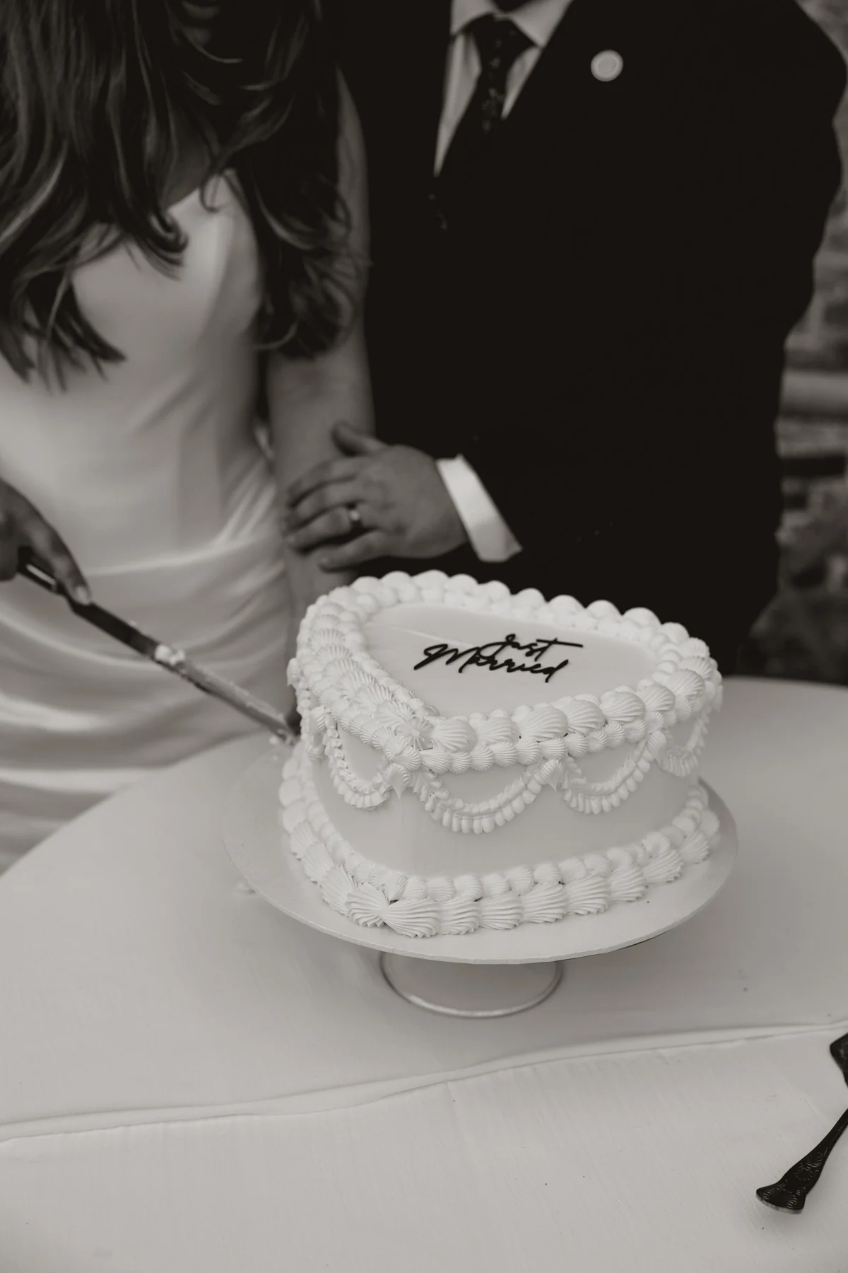Newlyweds cutting their wedding cake