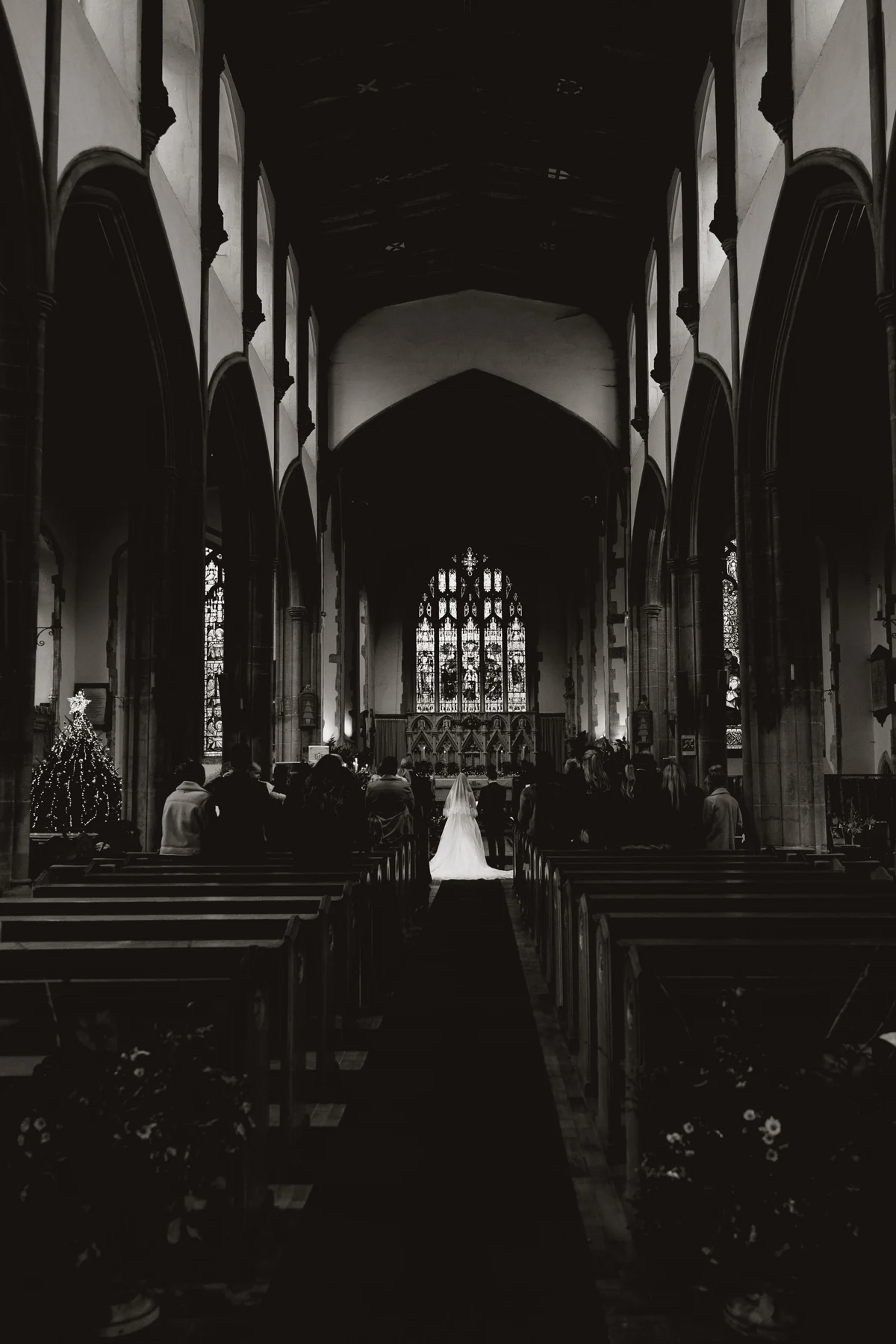 A wedding ceremony framed by the soaring architecture of a church